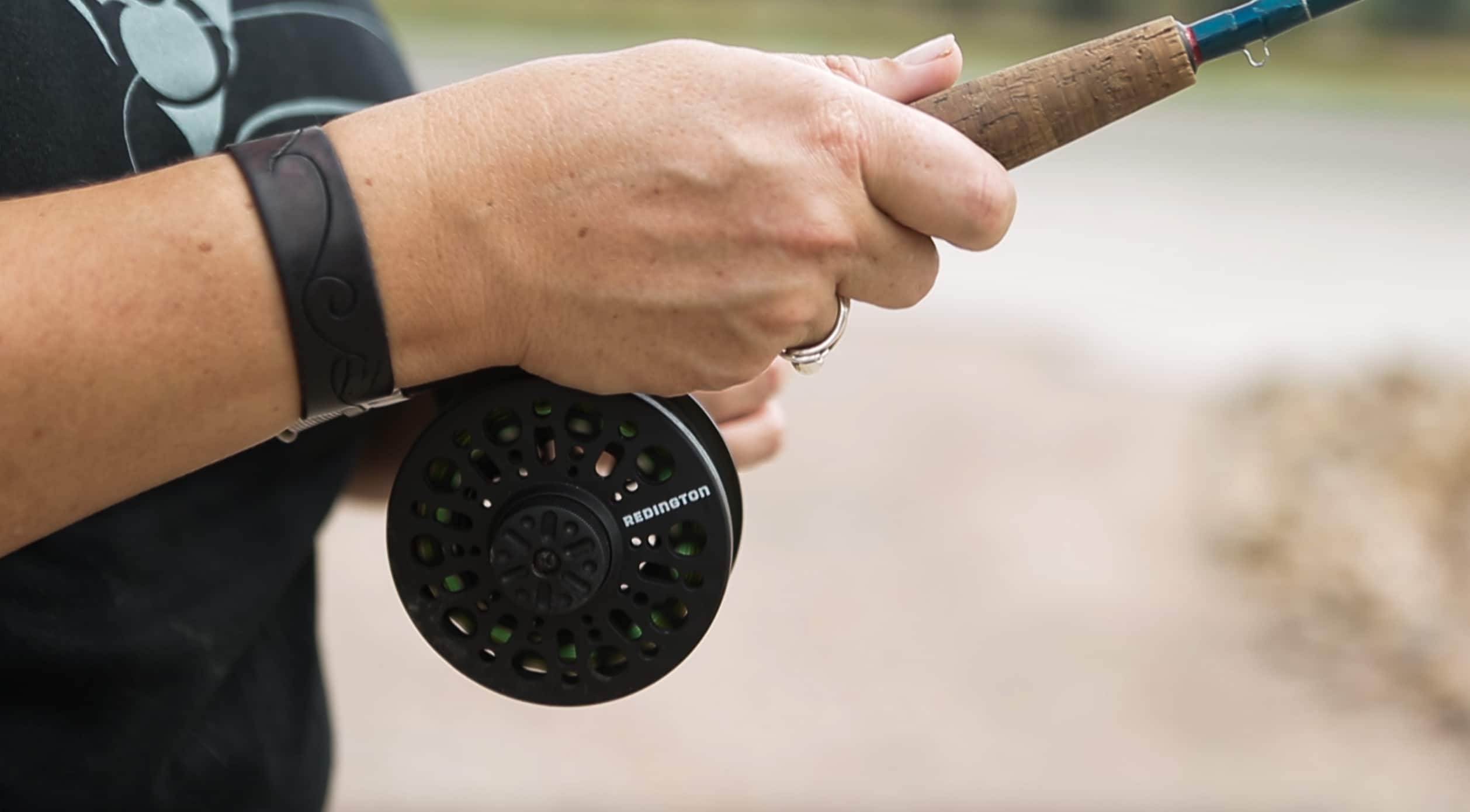 woman holding fly fishing rod